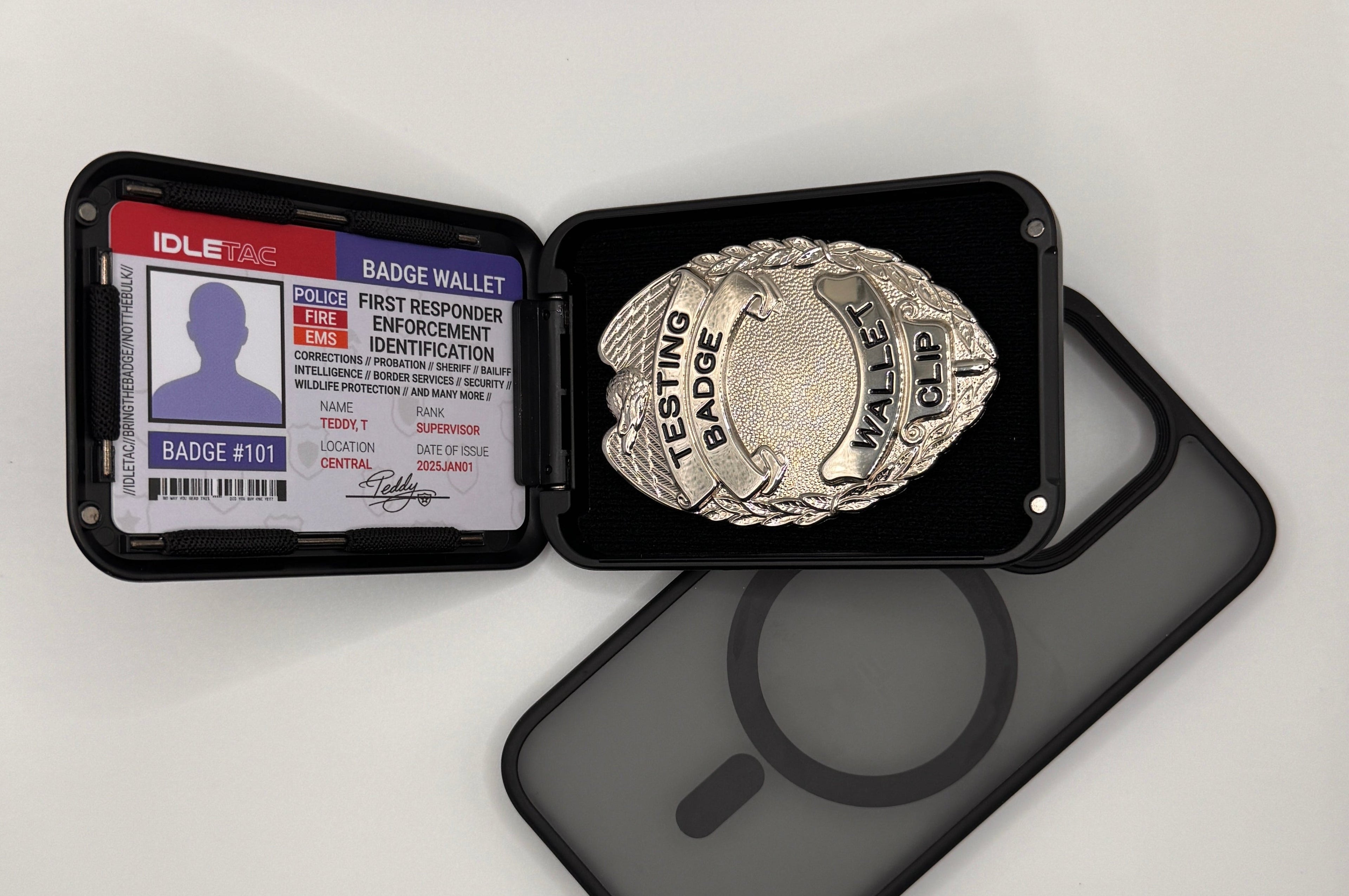Police badge and ID card in a holder on a white surface