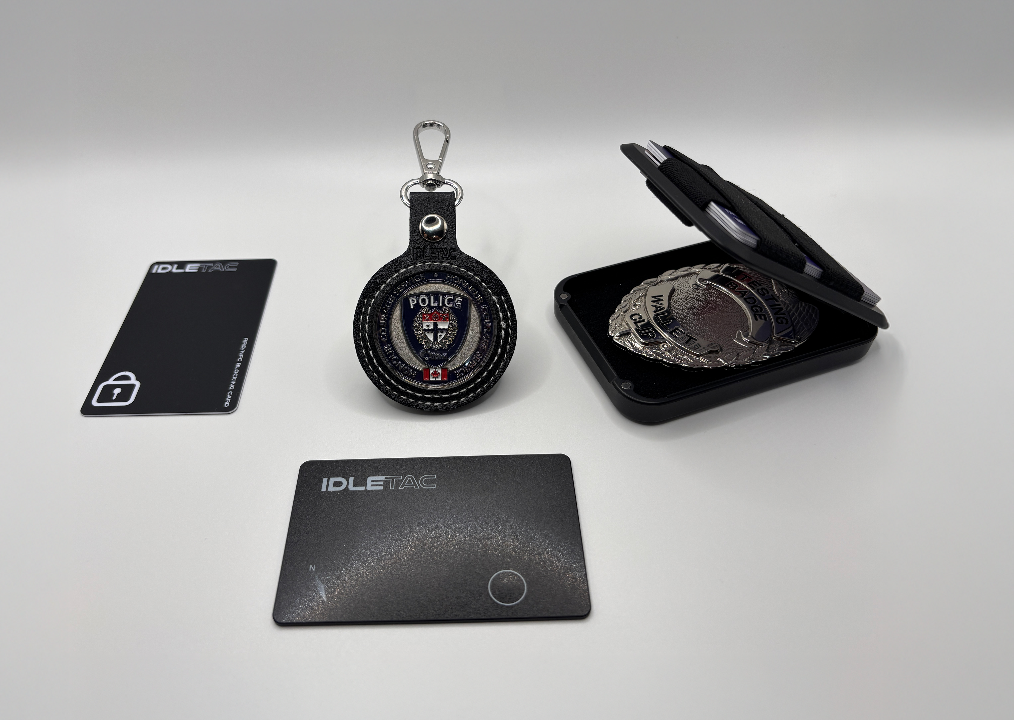 Police keychain, badge wallet, and cards on a white background