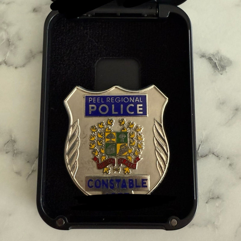 Peel Regional Police badge in a black case on a marble surface