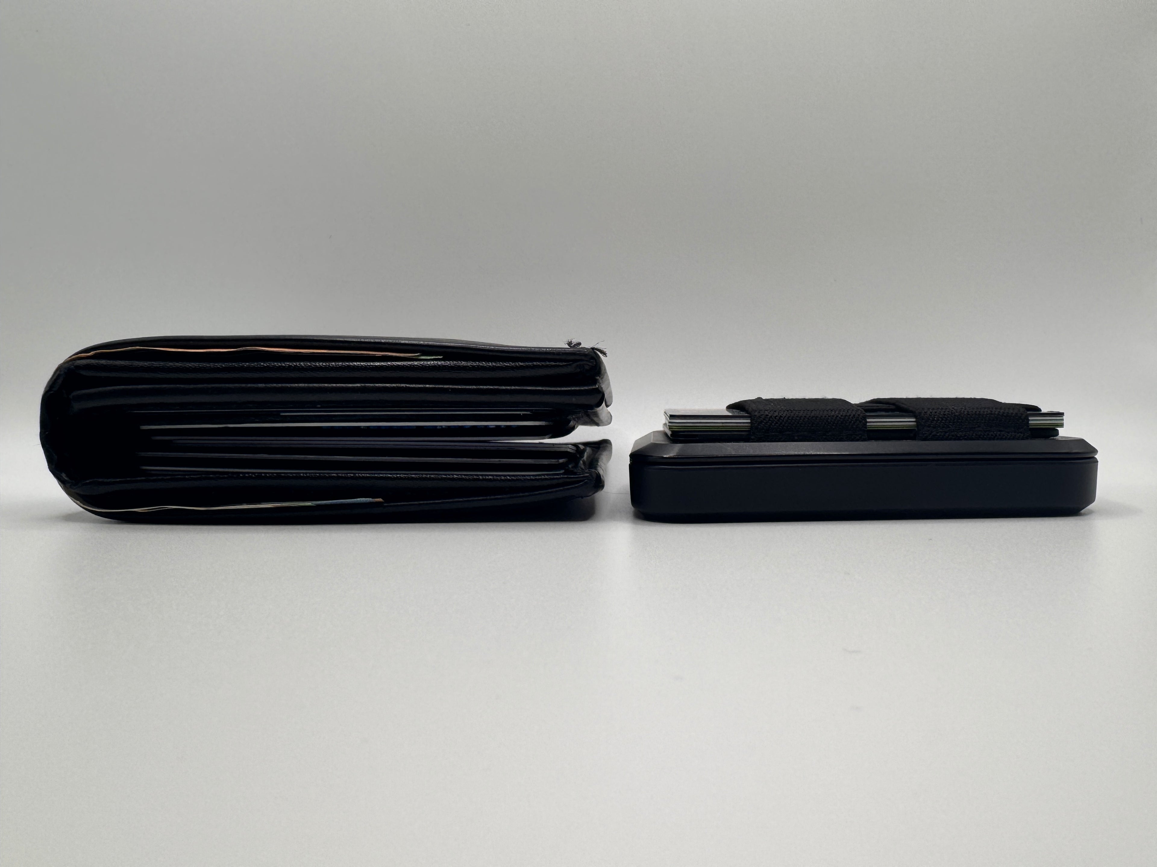 Two Badge Wallets compared that show the IDLETAC badge wallet as thinner